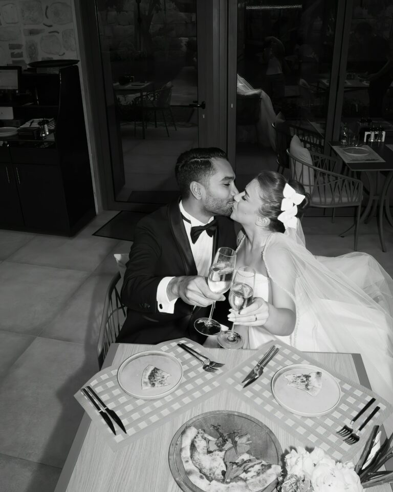 Married couple kissing during a dinner